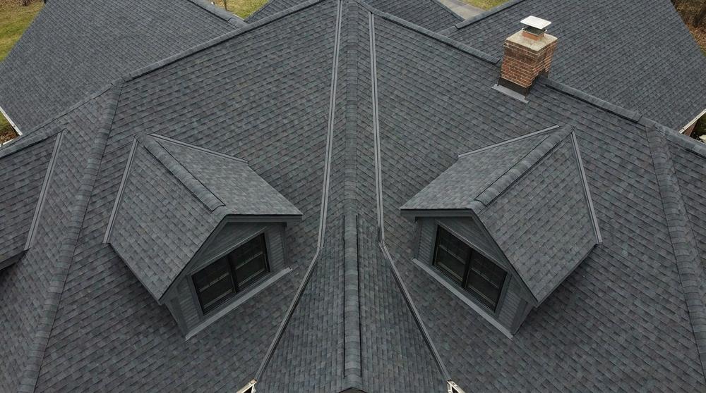 Complex residential roof with multiple valleys, dormers and a chimney