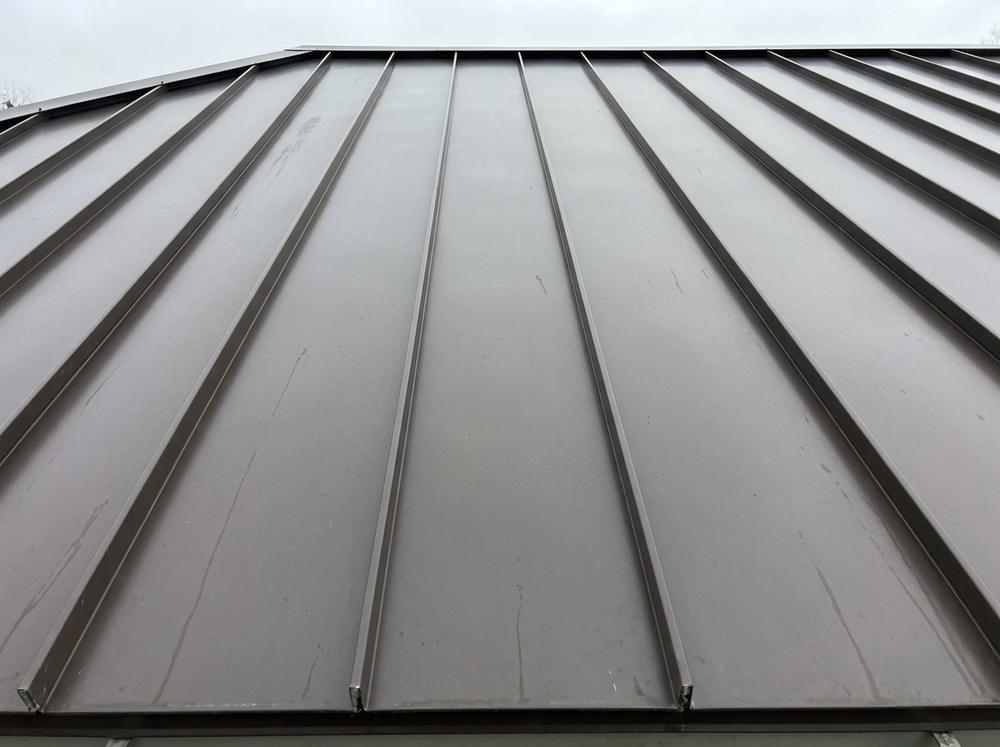 Standing seam metal roof with raised vertical seams and no visible fasteners