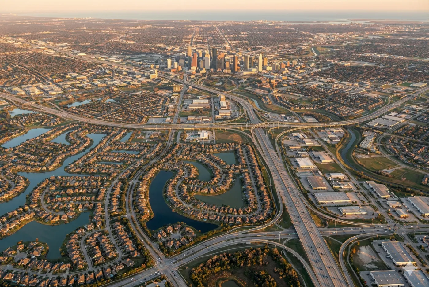 Aerial view of Houston, Texas metro area showing residential neighborhoods, downtown skyline, and waterways