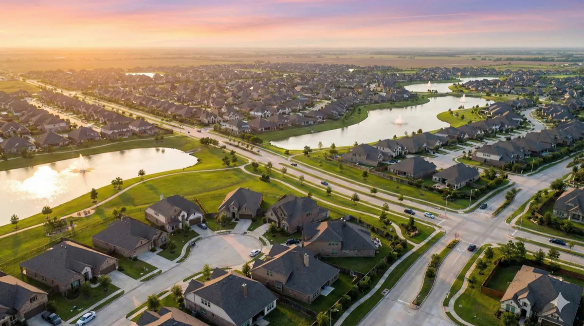 Aerial sunset view of Katy, Texas master-planned community with lakes
